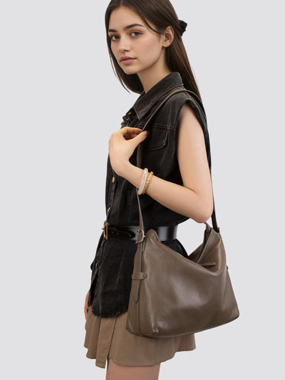 Khaki leather bag held by a model