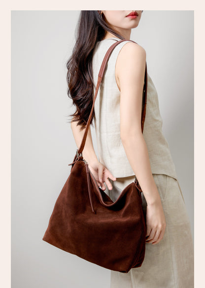 Brown tote carried under the arm with a relaxed outfit
