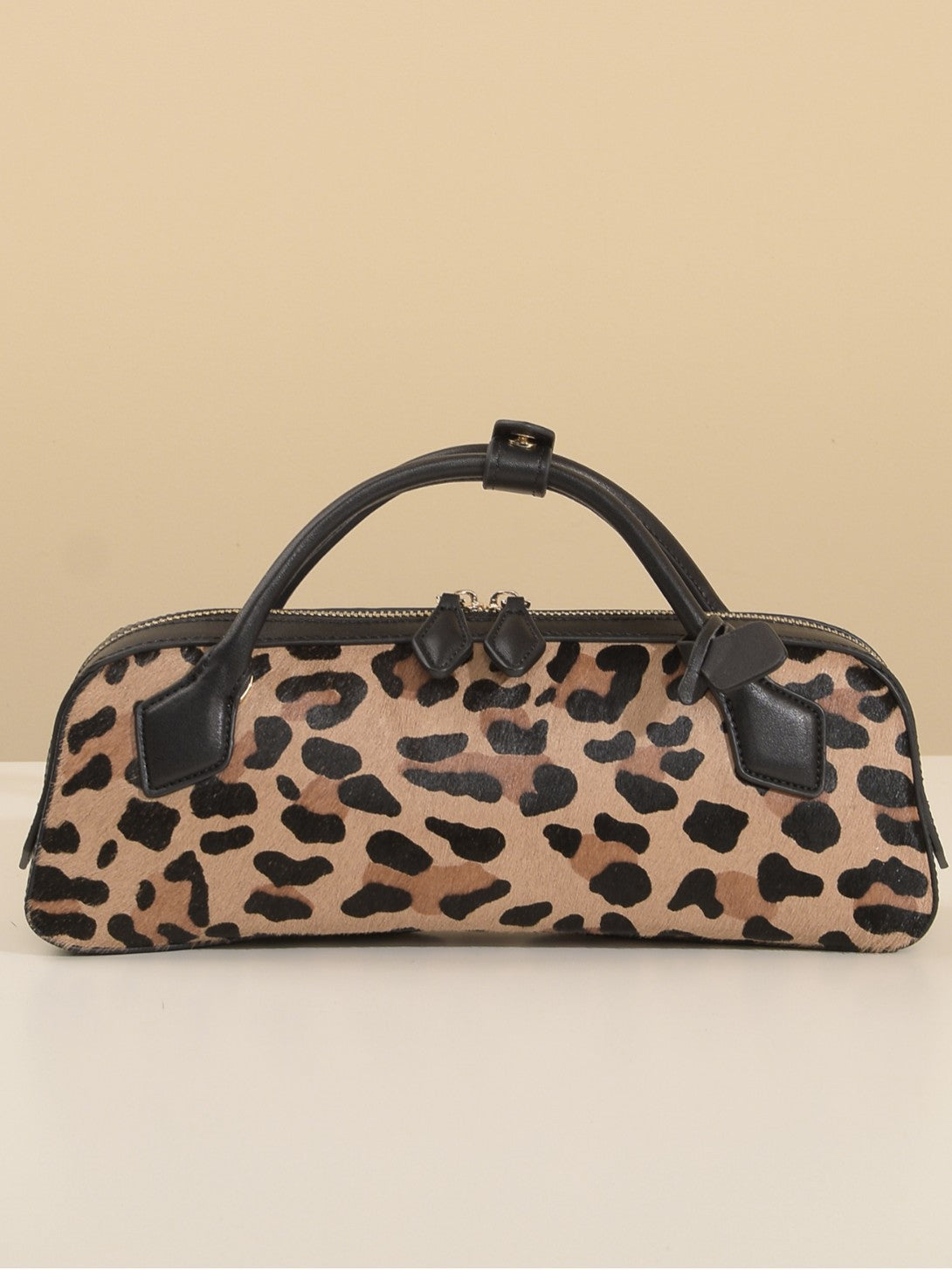 Front view of brown leopard-print cowhide shoulder bag with black top handles