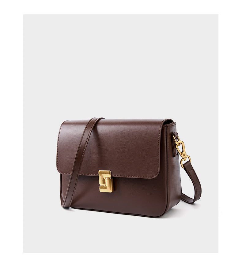 Coffee cowhide crossbody bag three-quarter view showing flap and hardware