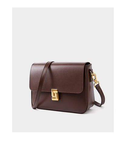 Coffee cowhide crossbody bag three-quarter view showing flap and hardware
