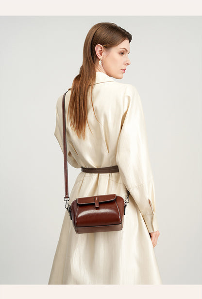 Back view of model wearing a brown crossbody bag across the body