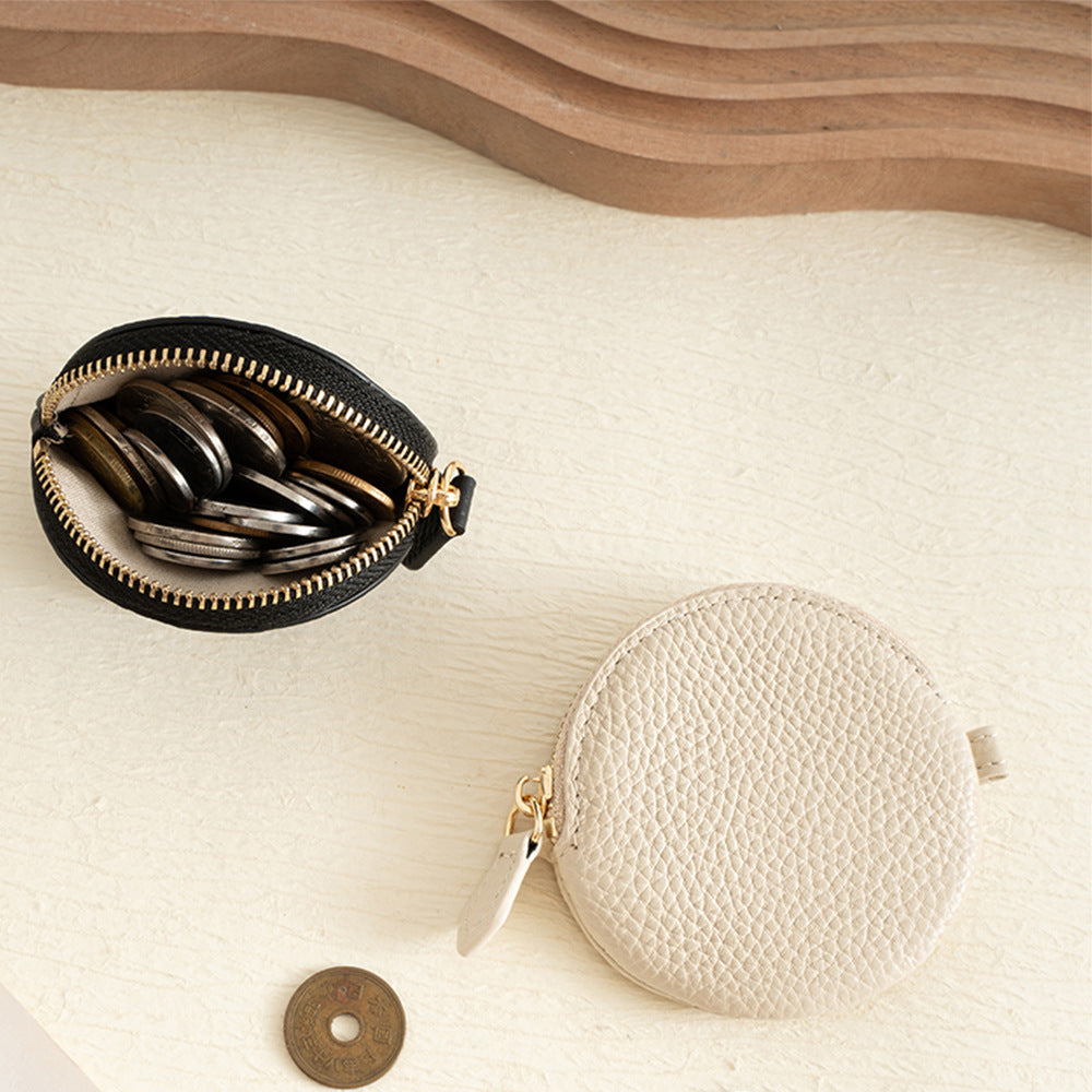 Cowhide Leather Mini Round Zip Pouch shown open, with the interior and its contents visible