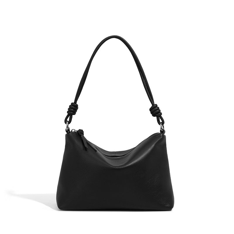 Black pebbled cowhide leather pillow tote bag on white background