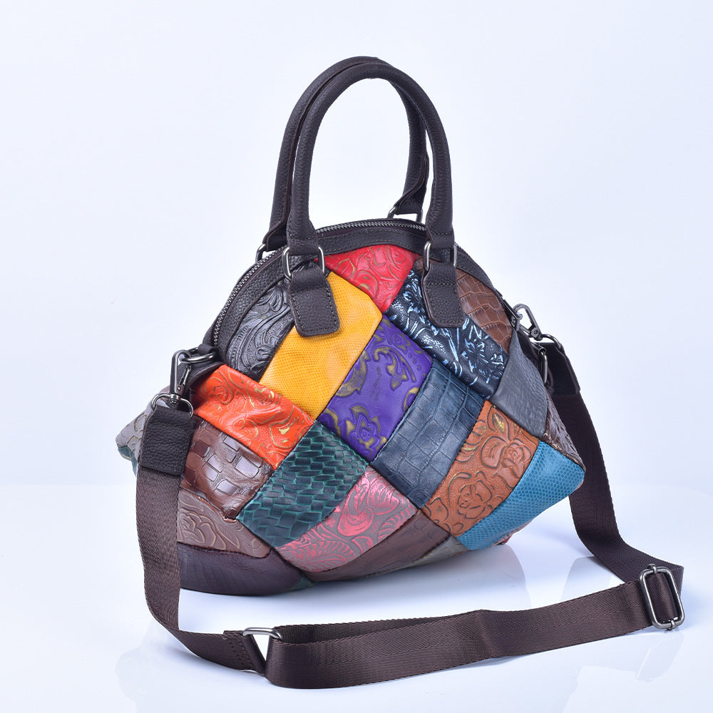 Patchwork cowhide handbag with detachable shoulder strap on white background