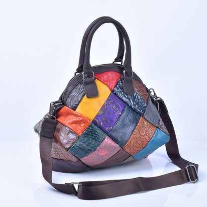 Patchwork cowhide handbag with detachable shoulder strap on white background