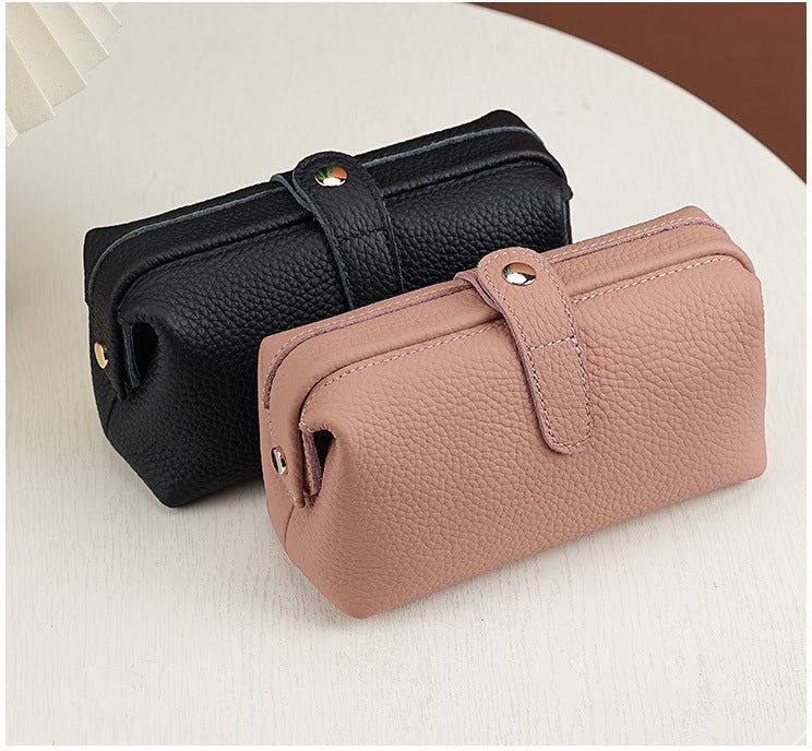 Black and blush pink pebbled cowhide cosmetic pouches with snap closures