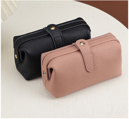 Black and blush pink pebbled cowhide cosmetic pouches with snap closures