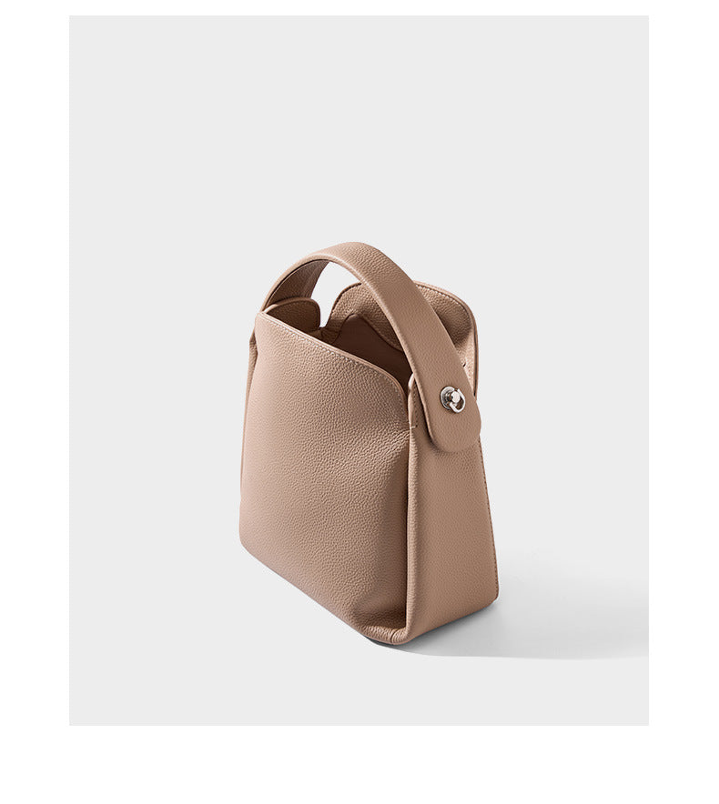 Side profile of pebbled cowhide leather handbag showing structure
