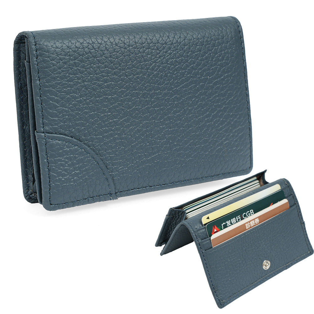Dark blue pebbled cowhide leather card holder showing tiered card slots open