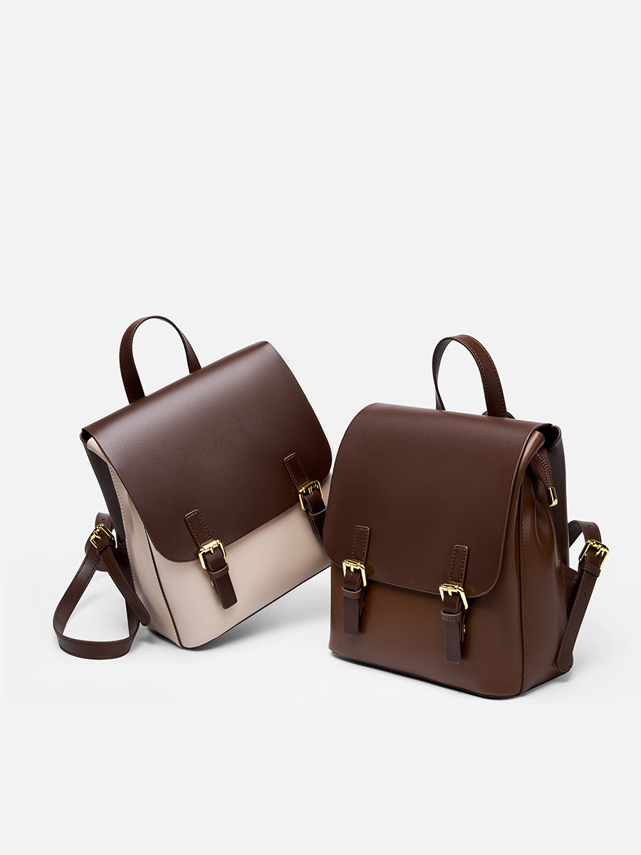 Side-by-side view of the two-tone and solid dark brown cowhide leather backpacks on a light background