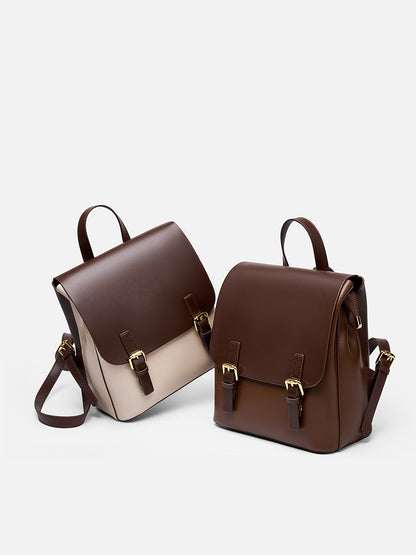 Side-by-side view of the two-tone and solid dark brown cowhide leather backpacks on a light background