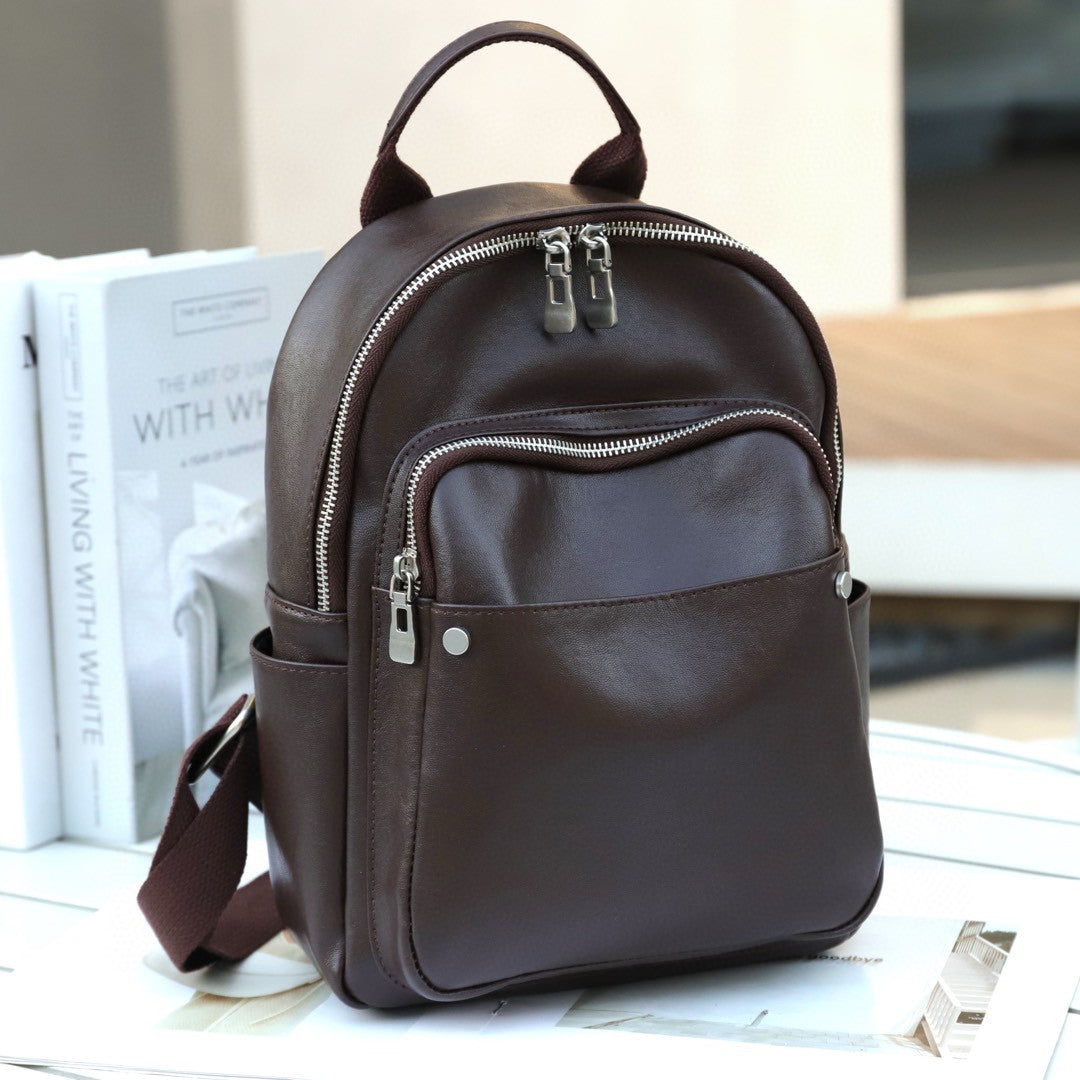 Chocolate cowhide backpack showing front and side pockets