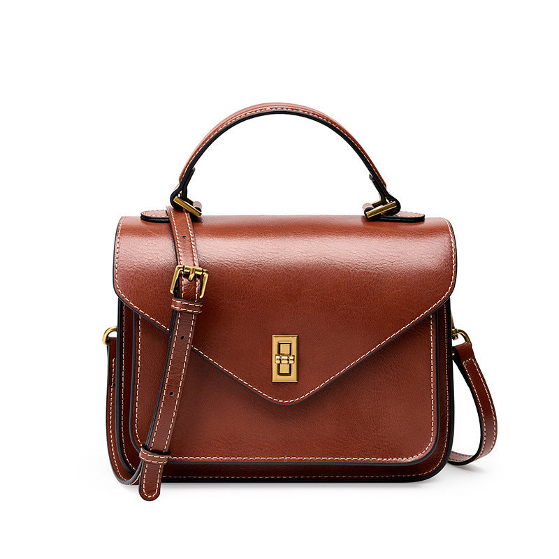 Brown cowhide leather envelope flap messenger bag with gold-tone hardware