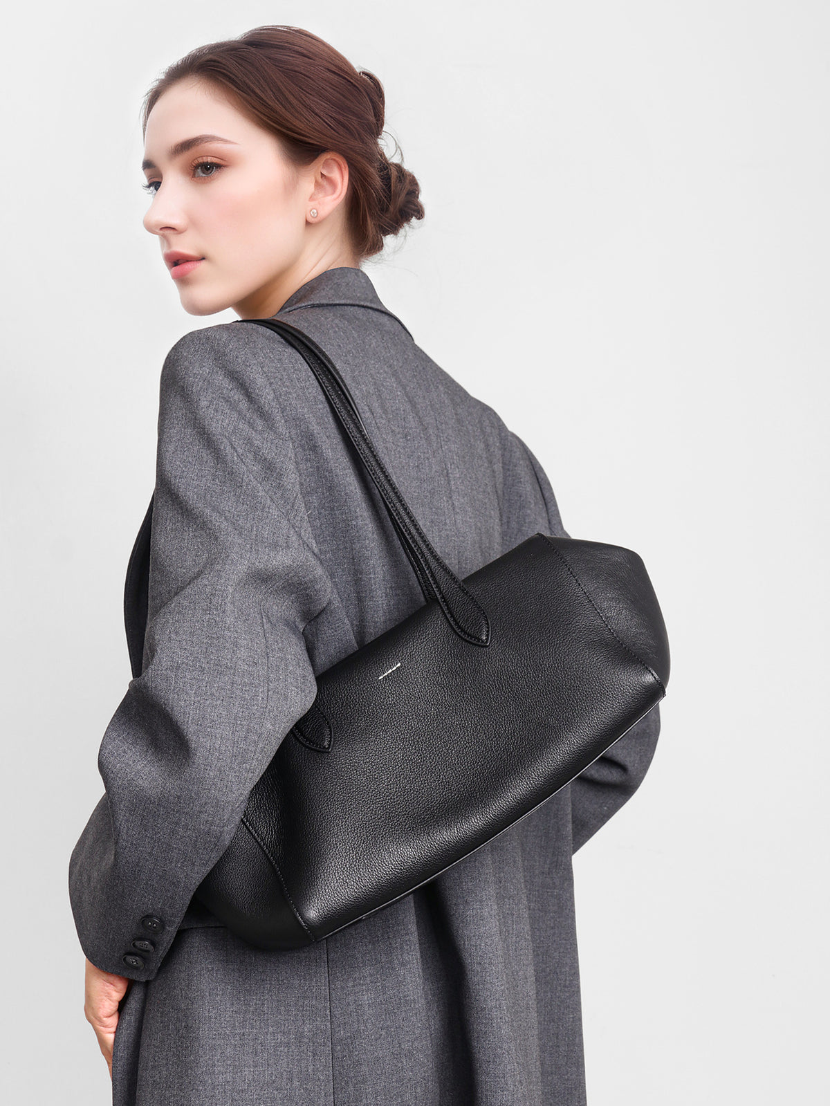 Close-up lifestyle view of the black shoulder tote
