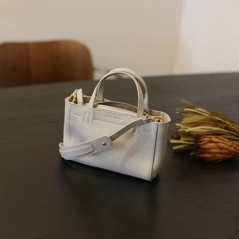 Pearl gray cowhide mini tote in a three-quarter view
