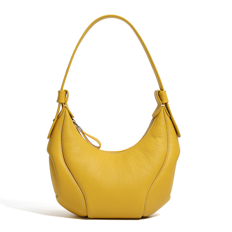 Yellow crescent leather bag side profile showing curved silhouette