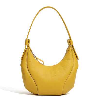 Yellow crescent leather bag side profile showing curved silhouette