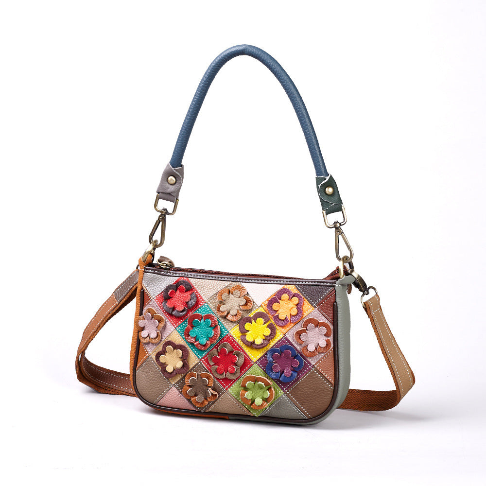 Front view of multicolor cowhide patchwork crossbody bag with flower appliques