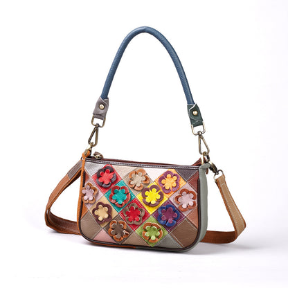 Front view of multicolor cowhide patchwork crossbody bag with flower appliques