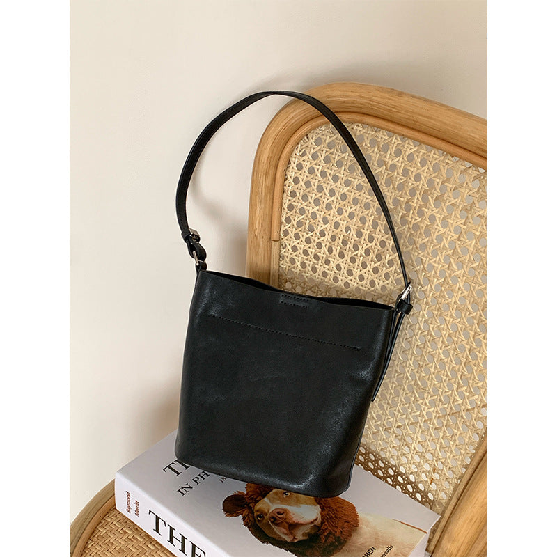 Black cowhide bucket bag with single shoulder strap