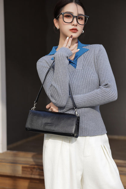 Model holding the black bag by its strap