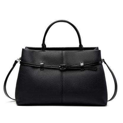 Black pebbled cowhide leather tote bag with top handles and front buckle detail on white background
