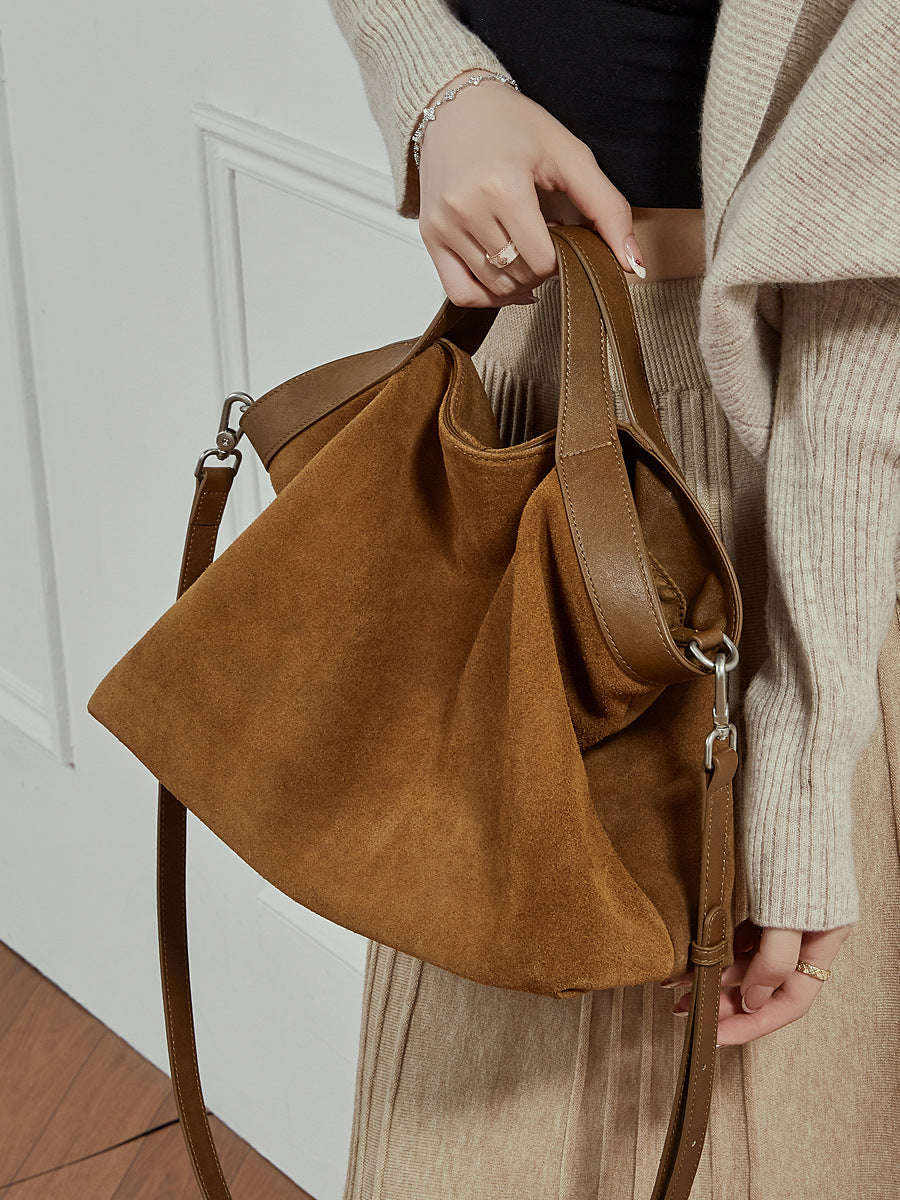 Close-up detail of nubuck leather texture and stitching on tote