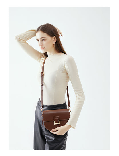 Model wearing the brown saddle bag crossbody, front view