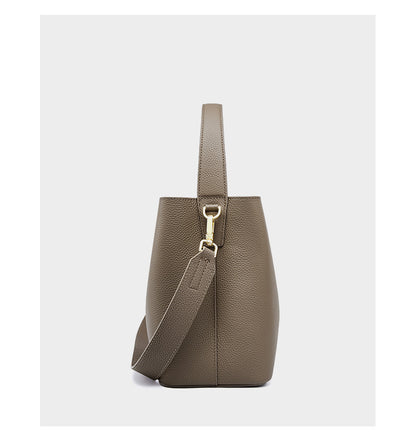 Khaki bucket bag side view showing adjustable strap detail