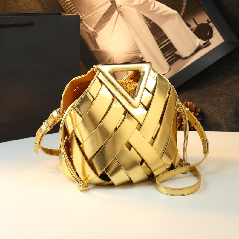 Gold woven leather bucket bag with long strap