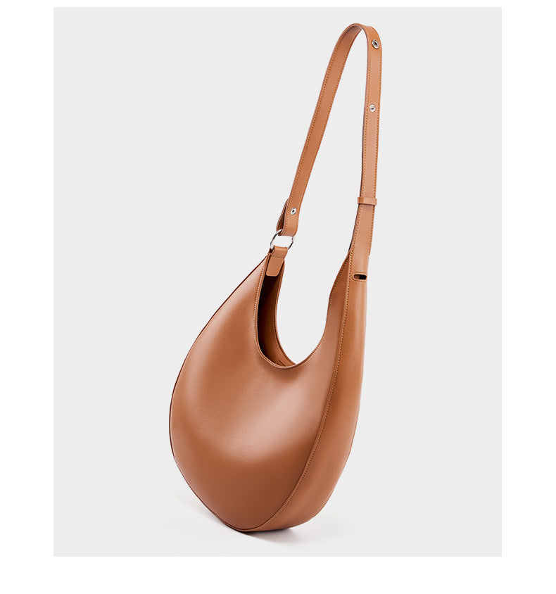 Light brown crescent hobo bag with strap extended showing adjustable length