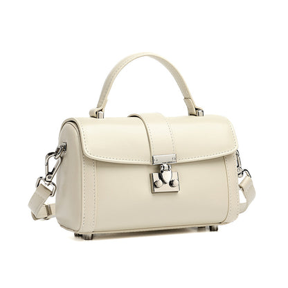 Off-white cowhide leather mini box crossbody bag with lock clasp on white background