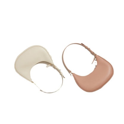 Side by side view of cream and pink crescent hobo bags