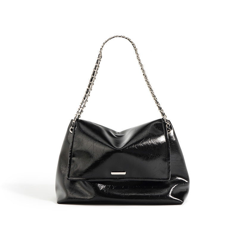 Black cowhide leather soft chain shoulder bag with chain strap on white background