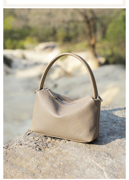 Gray pillow bag sitting on a stone ledge outdoors