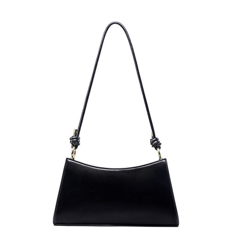 Black cowhide leather underarm shoulder bag with knotted strap on white background