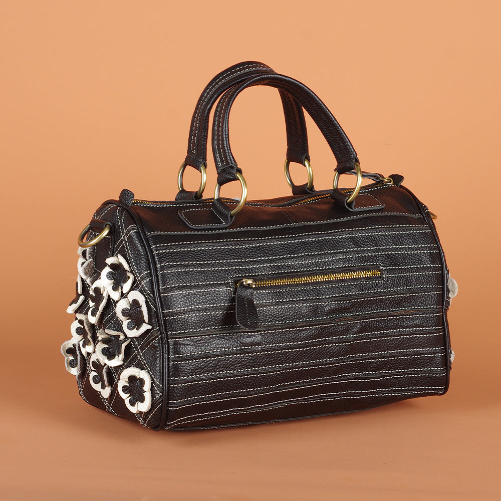 Rear zip pocket and stitched leather detail on floral crossbody bag