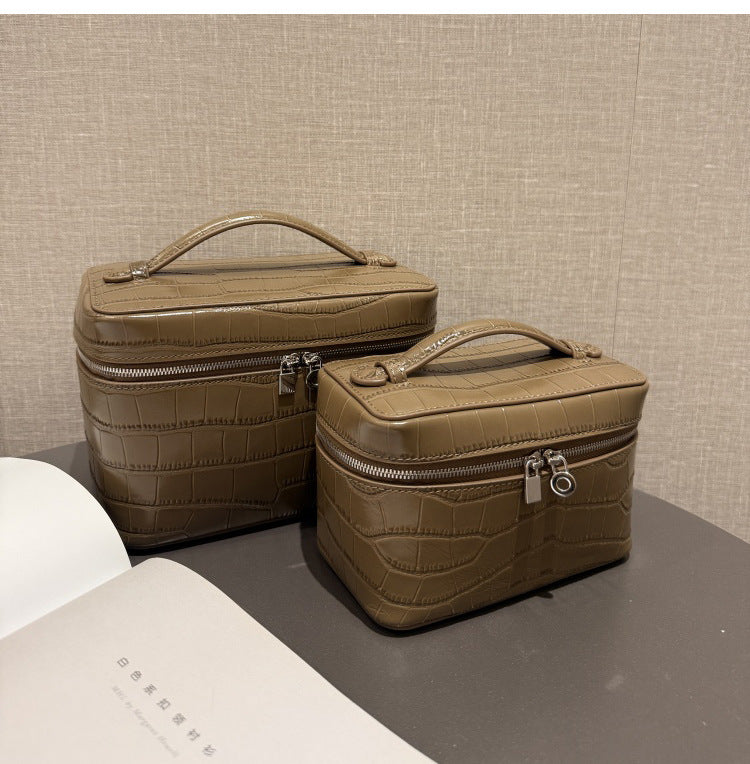 Dove gray crocodile-embossed cosmetic pouches shown together