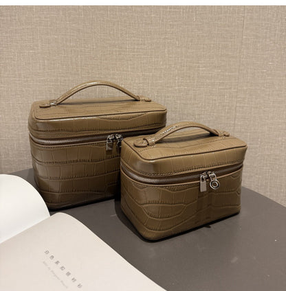 Dove gray crocodile-embossed cosmetic pouches shown together