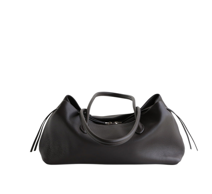 Black tote viewed from the front with handles lowered