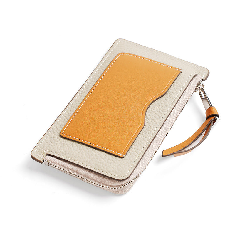 Cream and orange color-block mini wallet with exterior card slot on white background