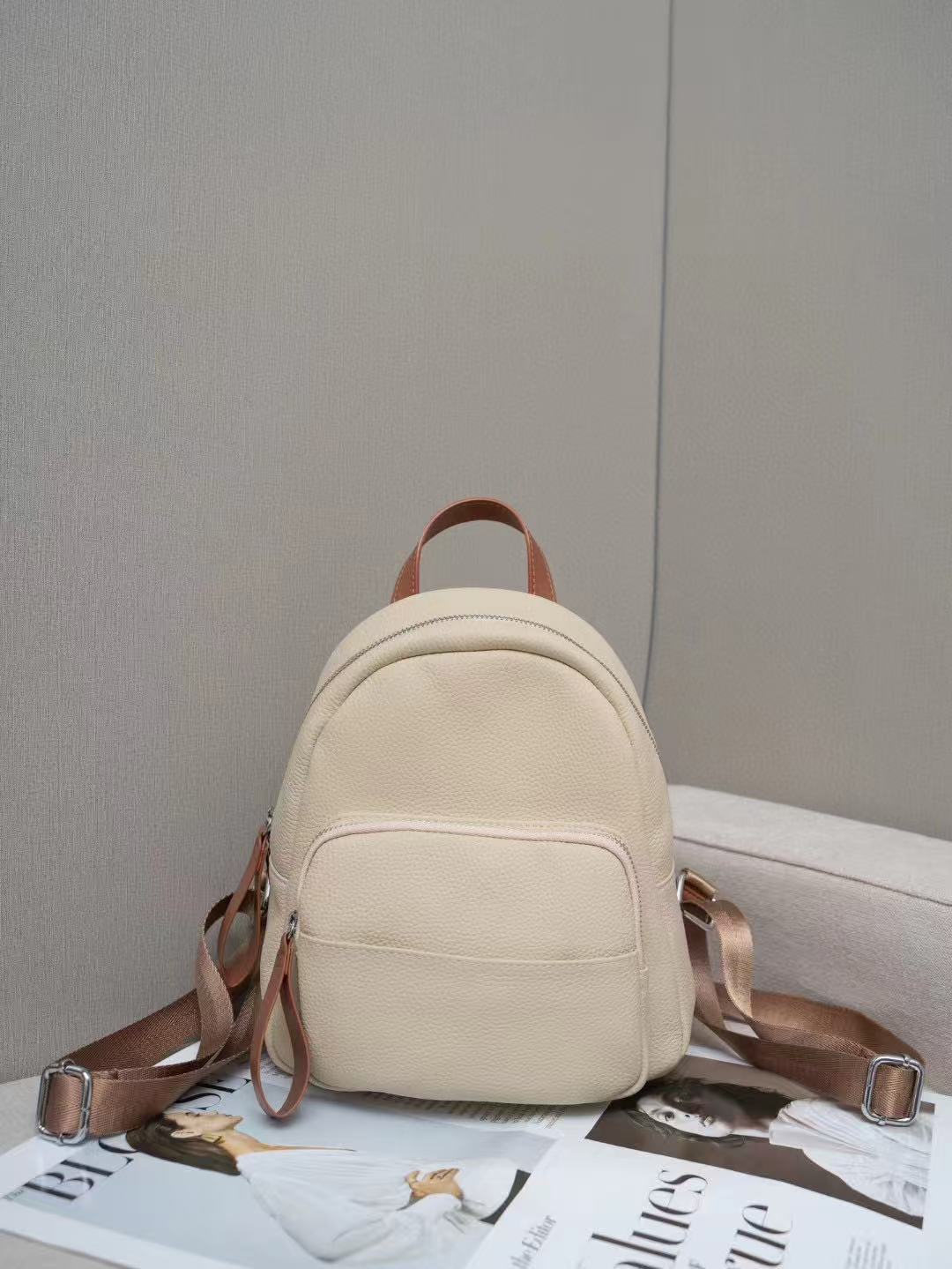 Ivory mini backpack displayed with shoulder straps