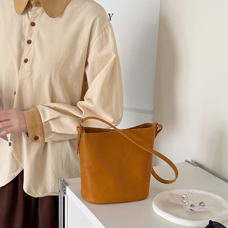White bucket bag with a single shoulder strap