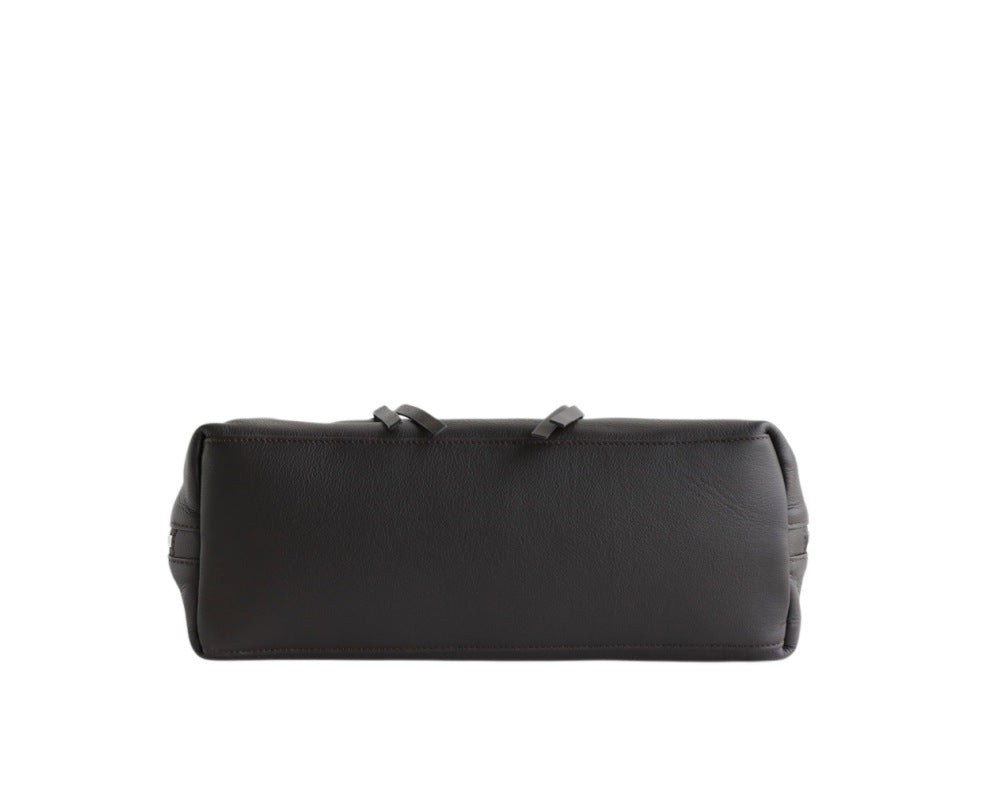 Close view of nubuck tote shape and shoulder handles