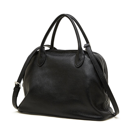 Front view of a black pebbled cowhide leather bowling tote bag on a white background