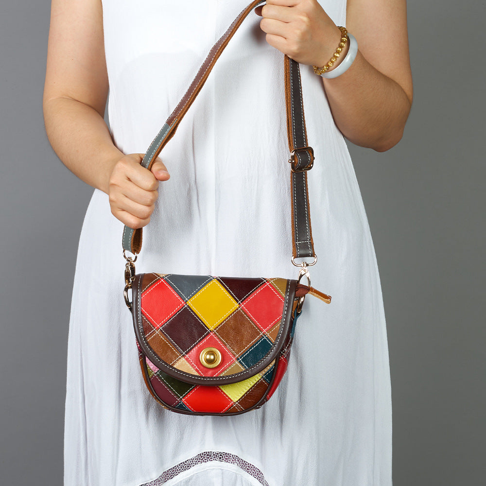 Bag held by its strap to show how it carries