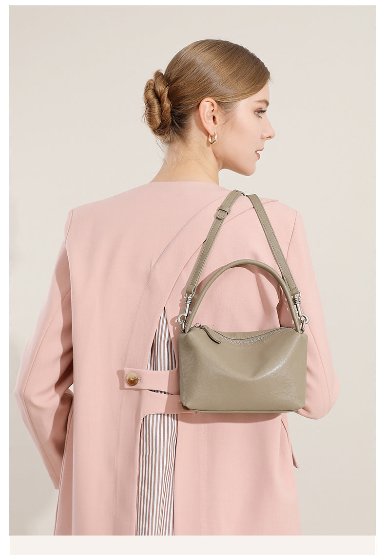 Back view of a model wearing the gray pillow bag crossbody