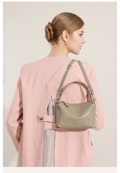 Back view of a model wearing the gray pillow bag crossbody
