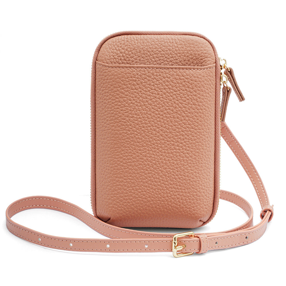 Pink pebbled leather phone bag with gold buckle strap front view